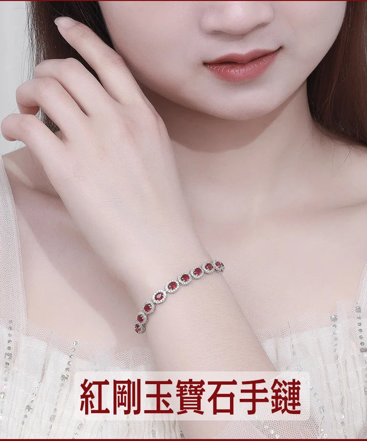 Close-up of a woman wearing a red gemstone bracelet with a blurred background