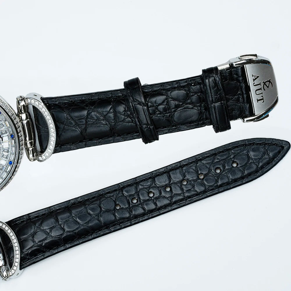 Black crocodile leather watch strap with silver buckle on a white background