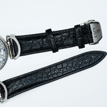 Black crocodile leather watch strap with silver buckle on a white background