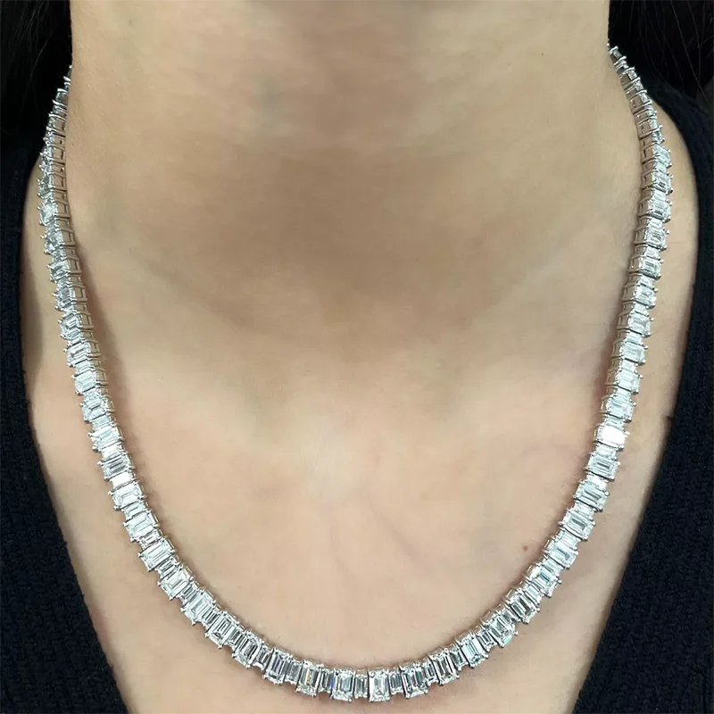 Diamond necklace on a person's neck with a blurred background