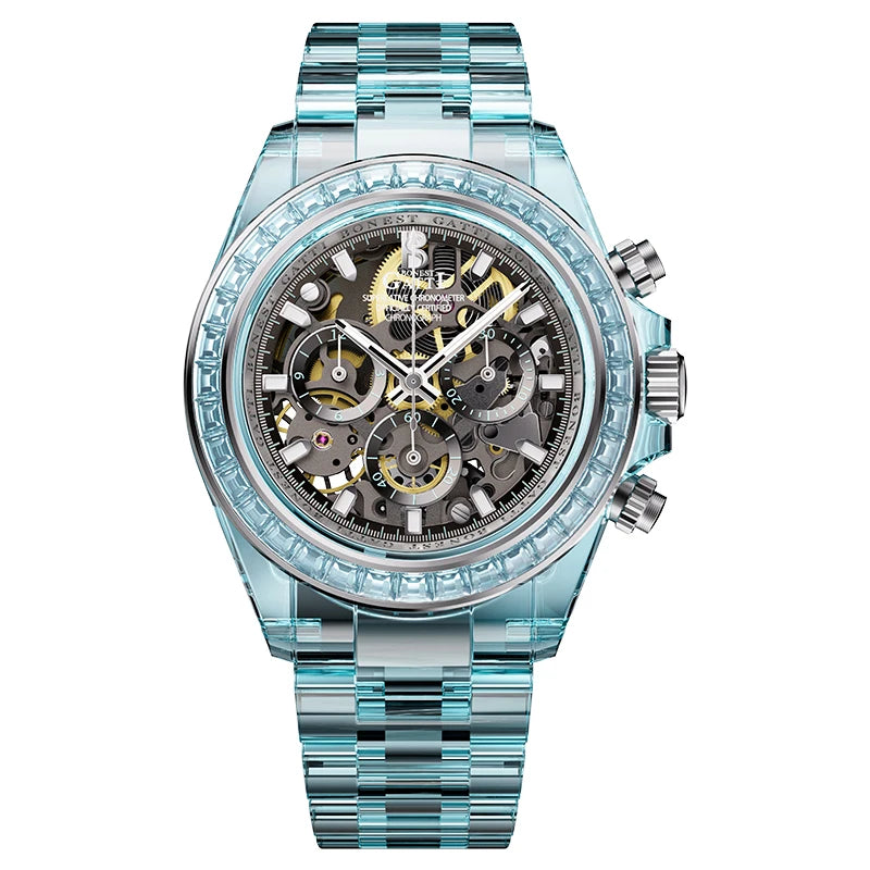 A luxury chronograph watch featuring a transparent light blue crystal case, a silver-tone metal bracelet, and a detailed skeleton dial with gold and silver elements.