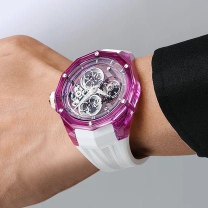 Wrist wearing a watch with a purple transparent case and white band on a plain background