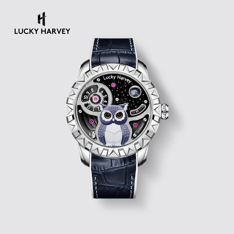 Lucky Harvey wristwatch with a silver-tone case, textured bezel, dark blue alligator leather strap, and a skeleton dial featuring a blue and white owl on a starry black background.