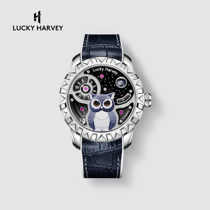 Lucky Harvey wristwatch with a silver-tone case, textured bezel, dark blue alligator leather strap, and a skeleton dial featuring a blue and white owl on a starry black background.