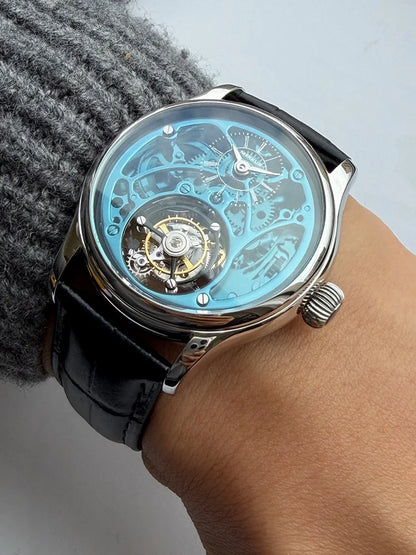 Sleek wristwatch with a black leather strap on a wrist, against a neutral background