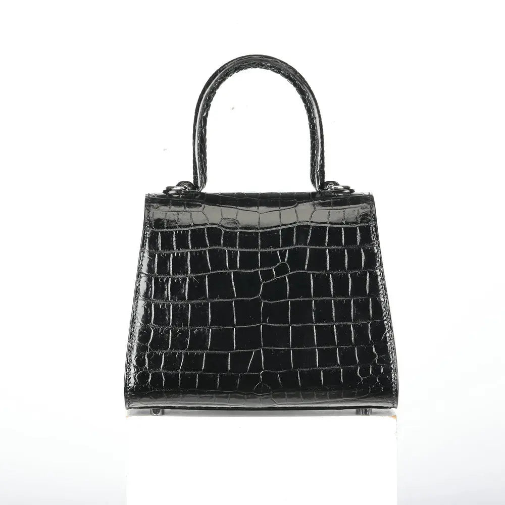 A structured black crocodile-embossed leather handbag with a top handle, displayed against a plain white background.