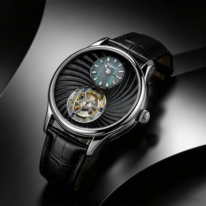 A luxury wristwatch with a black leather strap, a silver-toned case, and a distinctive black textured dial featuring a visible open-heart tourbillon and a green sub-dial.