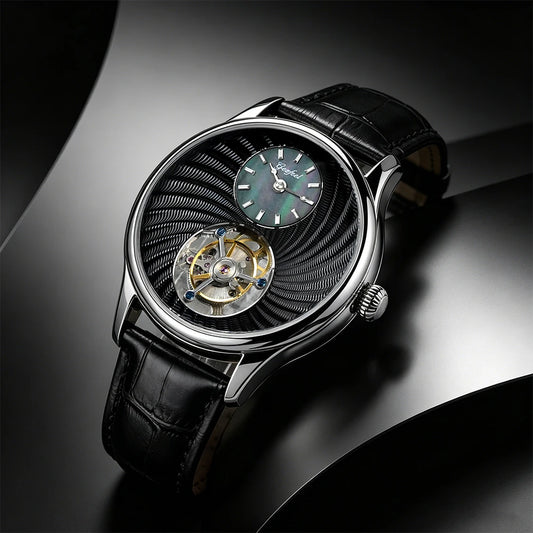 A luxury wristwatch with a black leather strap, a silver-toned case, and a distinctive black textured dial featuring a visible open-heart tourbillon and a green sub-dial.
