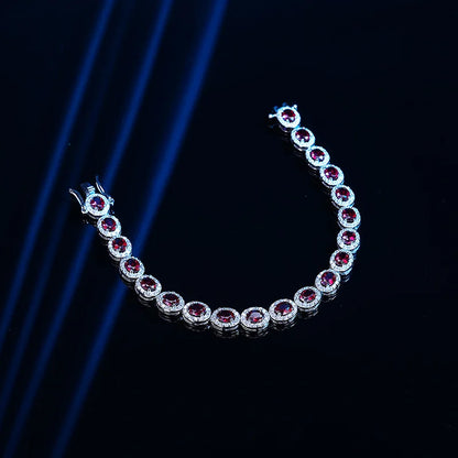Silver bracelet with red gemstones on a dark background
