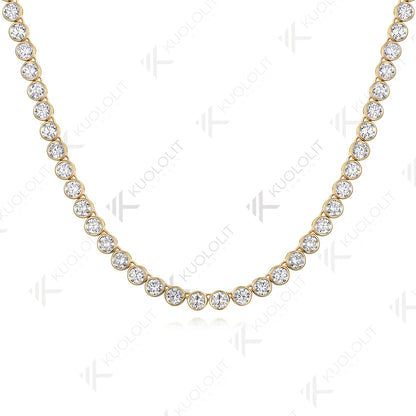 A yellow gold tennis necklace featuring round-cut clear gemstones in a classic bezel setting, displayed on a clean white background with a faint reflection.