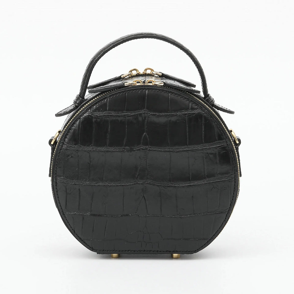 A black crocodile-embossed leather handbag with a top handle and gold-tone hardware, shown against a plain white background.