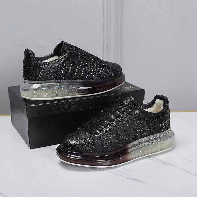 Black textured sneakers on a white surface with a gray background