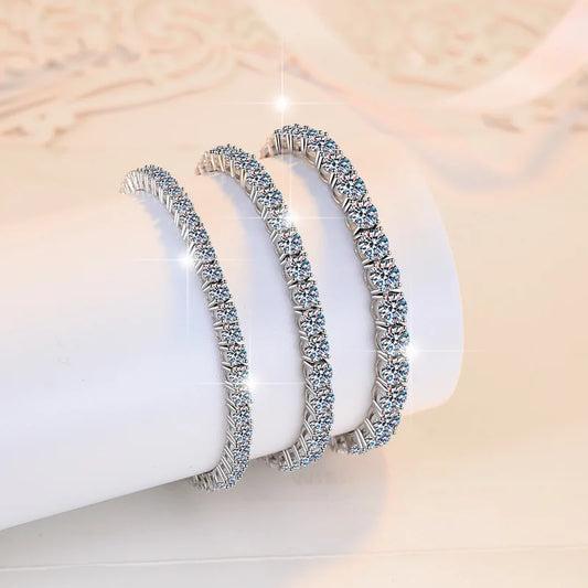 Pair of silver hoop earrings with clear stones on a white surface
