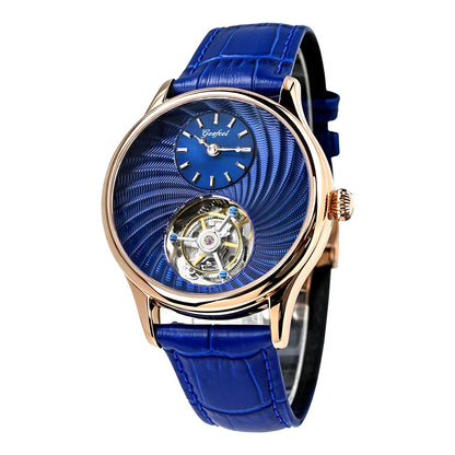 A luxury wrist watch featuring a vibrant blue textured dial, a visible mechanical movement through a cutout, and a matching blue leather strap with a rose gold case.