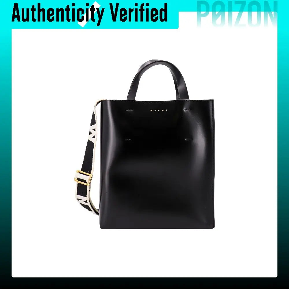 A black leather tote bag with double top handles and a detachable shoulder strap featuring a white and black patterned section with gold hardware, shown on a white background with a teal border and 'Authenticity Verified' banner.