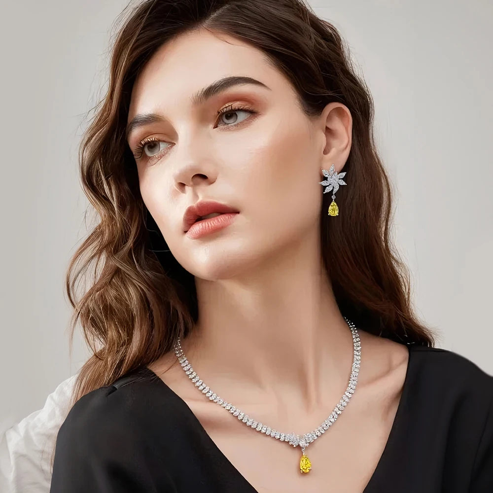 Woman wearing a necklace and earrings with a neutral background