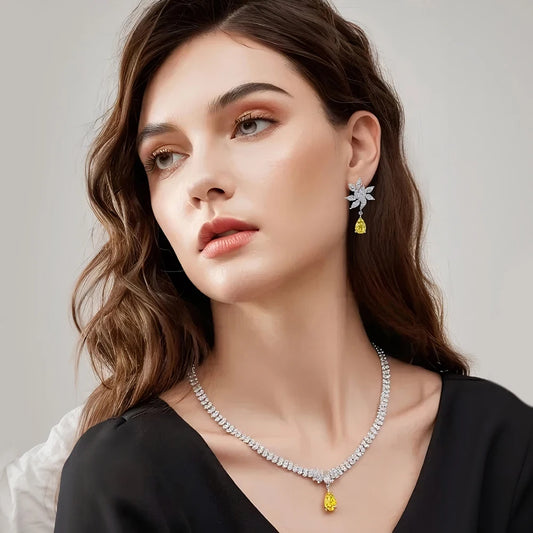 Woman wearing a necklace and earrings with a neutral background