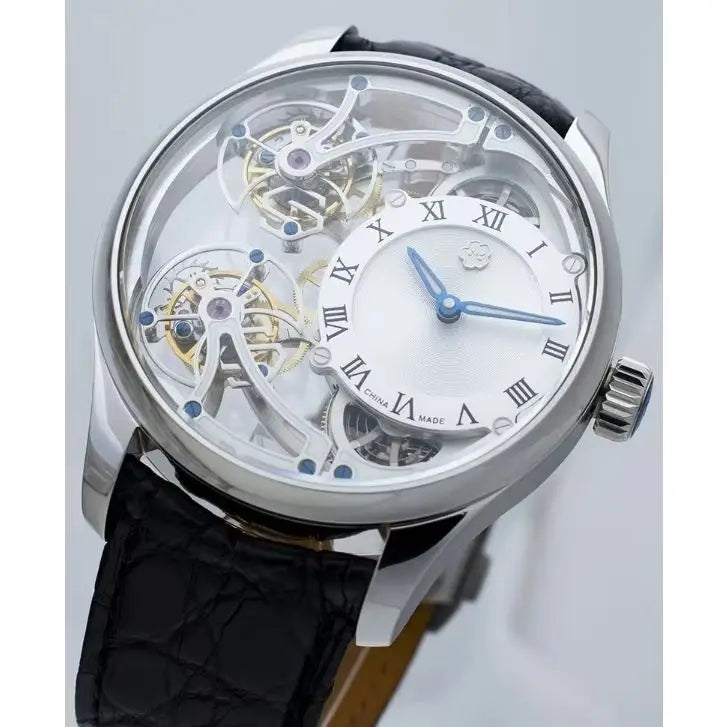 A luxury skeleton watch with a silver-tone case, transparent dial showing intricate mechanical gears, Roman numeral hour markers, blue hands, and a black leather strap.