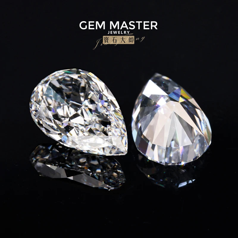 Two pear-shaped diamonds on a black background with 'Gem Master Jewelry' branding.