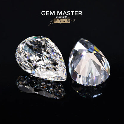 Two pear-shaped diamonds on a black background with 'Gem Master Jewelry' branding.