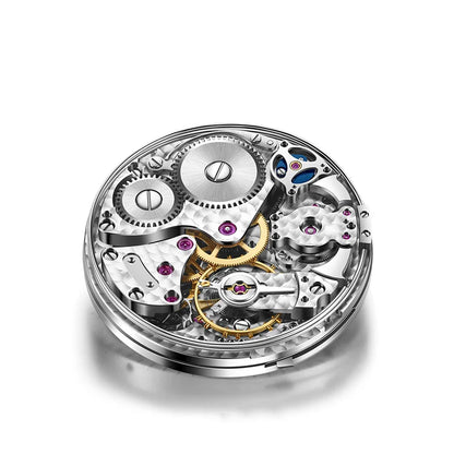 A close-up studio shot of a watch movement mechanism with silver-toned gears, gold-toned components, and small purple jewel bearings on a white background.