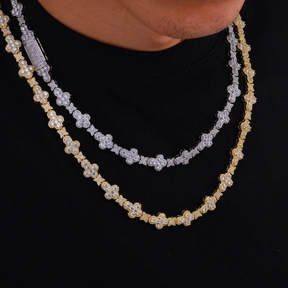 Two layered diamond-encrusted necklaces, one yellow gold and one silver, worn on a model's neck over a black shirt.