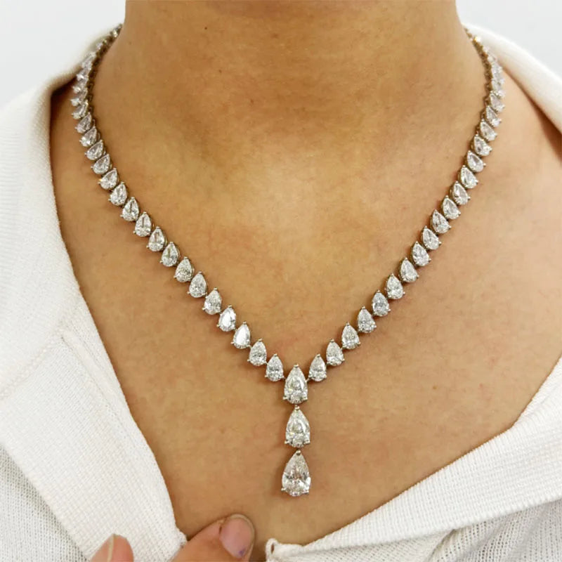 Diamond necklace on a person wearing a white top