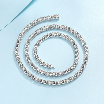 A silver tennis bracelet with clear crystals, arranged in a spiral on a light blue background.