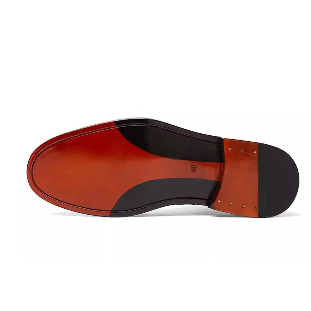 A close-up bottom view of a leather shoe sole, showing a glossy reddish-brown vamp, black heel counter and heel cap, and brass rivets on a white background.
