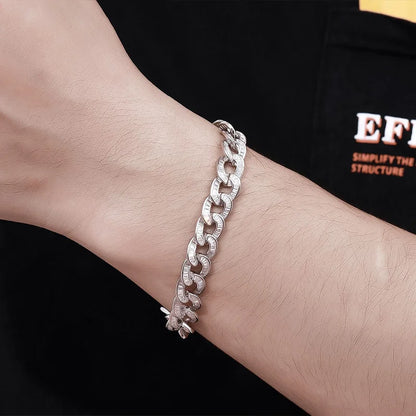 Silver chain bracelet on a wrist with a black background