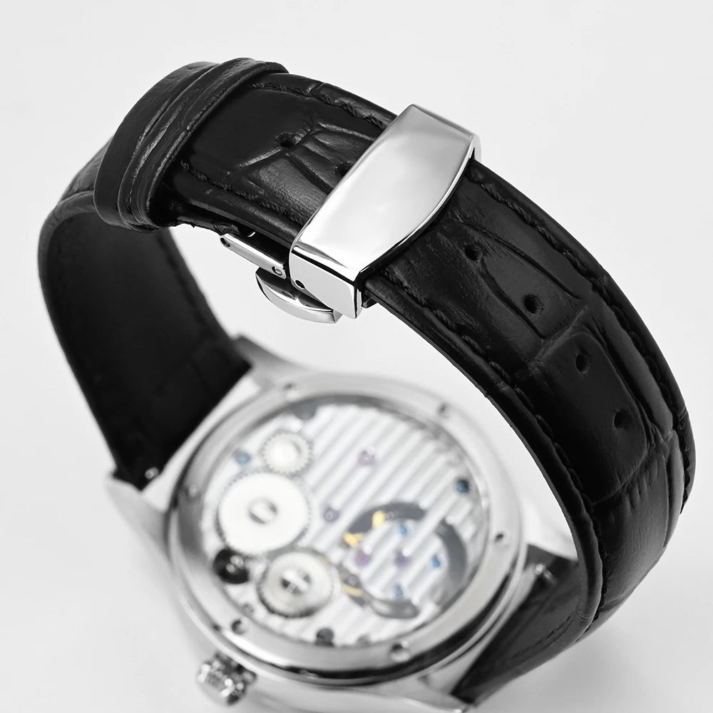Close-up of a watch with a black leather strap and silver clasp on a light gray background