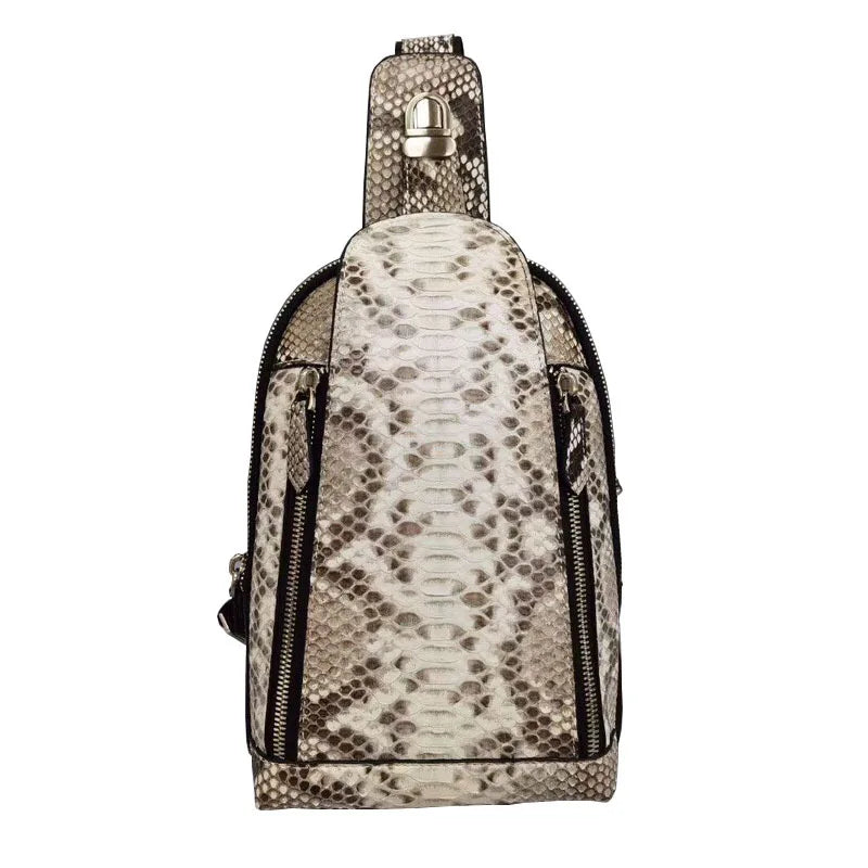 A snakeskin-patterned shoulder bag in beige and brown tones with black zippers and a silver-tone metal clasp on the strap, shown against a plain white background.