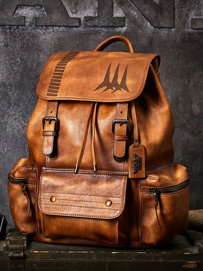 Brown leather backpack with visible branding on a dark background