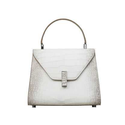A structured handbag with a crocodile-embossed texture in off-white and light beige, featuring a top handle, a flap front, and a silver-tone clasp, shown against a plain white background.