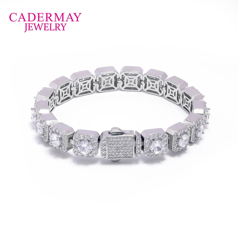 A silver-tone square-link bracelet with clear pavé-set stones and central round clear stones, shown on a white background with the CADERMAY JEWELRY logo in pink in the top left corner.