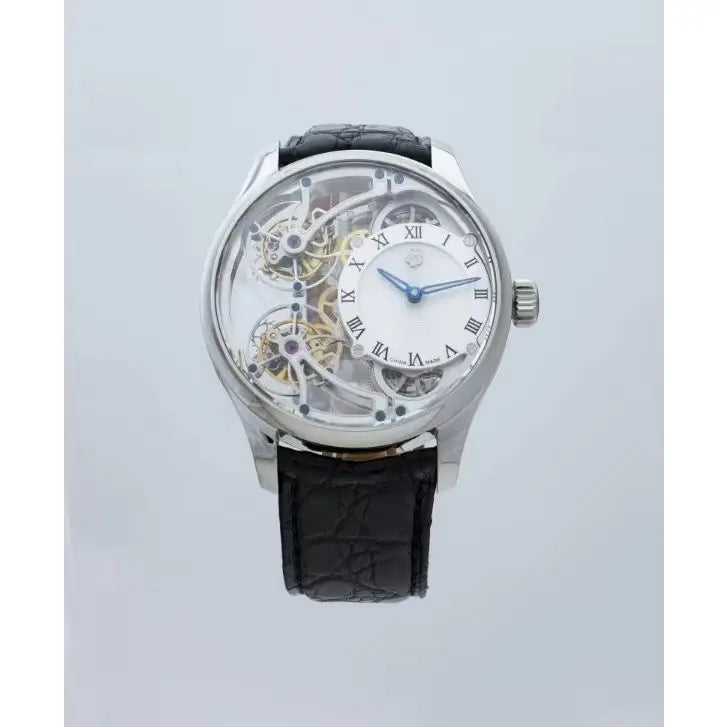 A luxury skeleton watch with a silver-toned case, a white dial with black Roman numerals, and a black textured leather strap, shown against a light gray background.