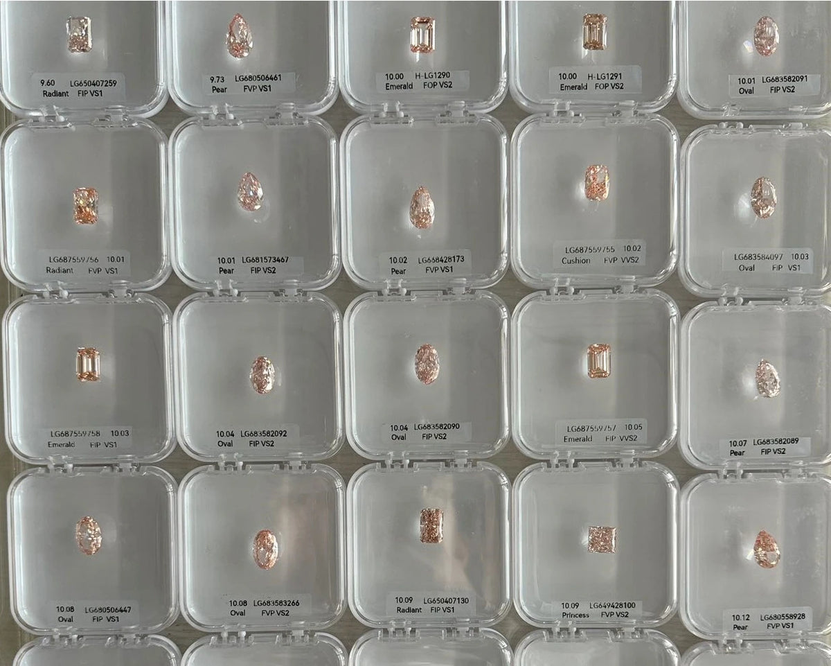 Multiple small diamonds in clear display cases on a grid pattern