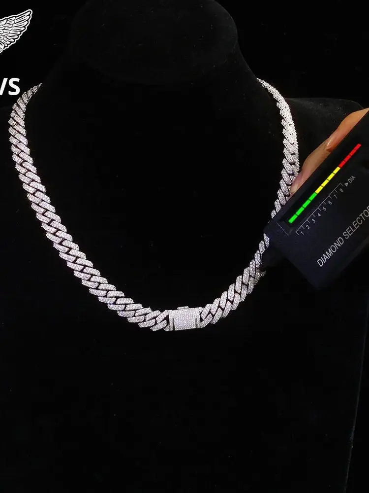 Silver chain necklace on a black background with a diamond tester device.