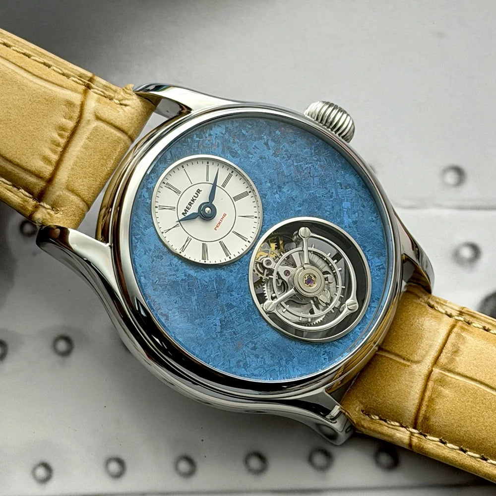Luxury watch with blue face and yellow leather strap on a metallic background