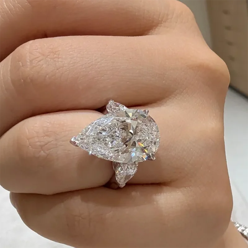 Pear-shaped diamond ring on a finger