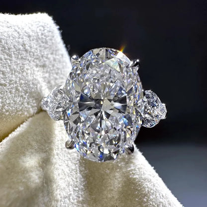 Diamond ring on a white cushion with a dark background
