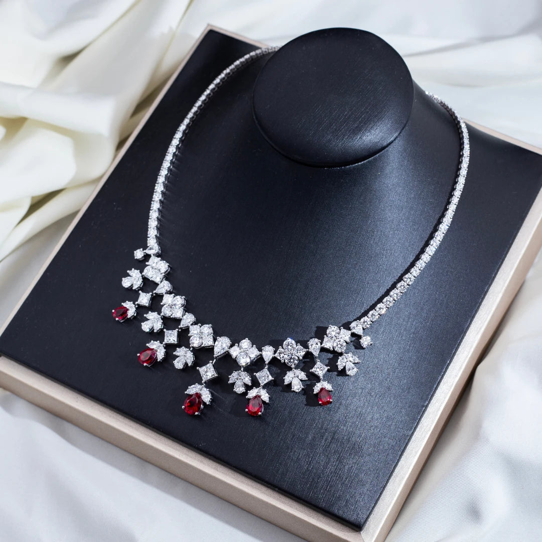 Necklace with red and clear stones on a black jewelry display