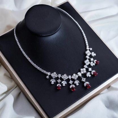 Elegant necklace with red gemstones on a black stand