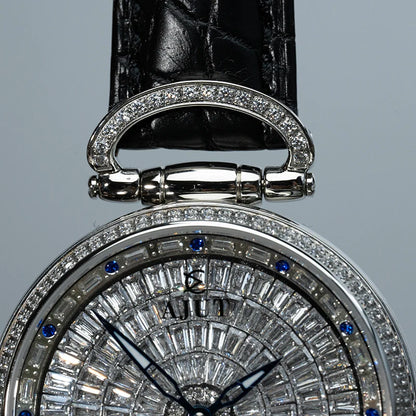 Close-up of a diamond-encrusted watch with a black leather strap on a gray background