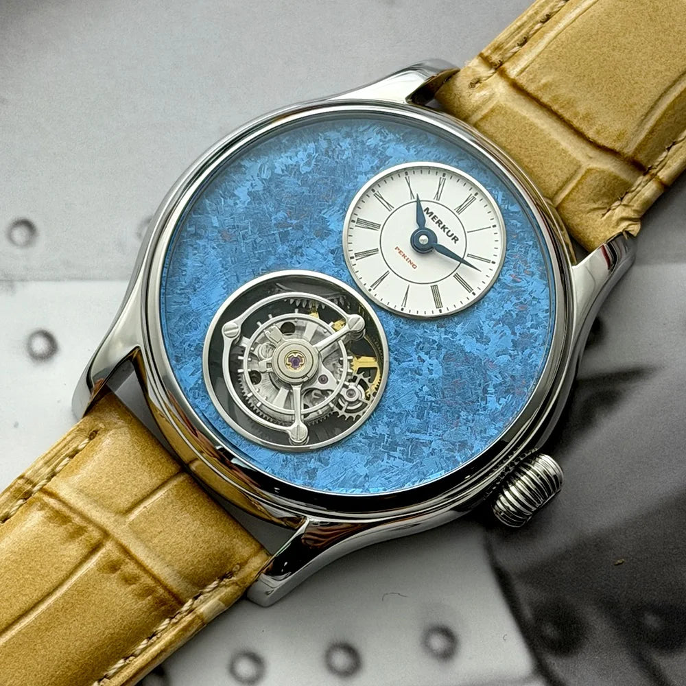 Watch with blue face and beige leather strap on a metallic background