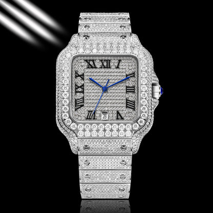 A luxury watch with a silver-toned square case and integrated bracelet, completely paved with sparkling clear stones. The dial is silver with black Roman numerals and vibrant blue hands, accented by a blue cabochon on the crown.